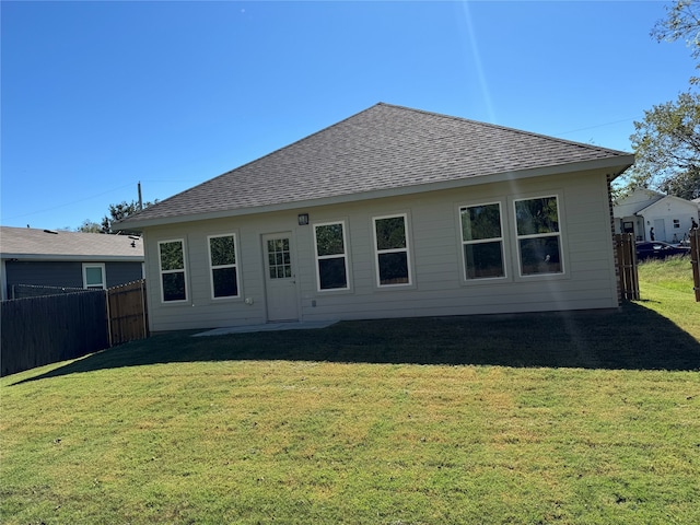 rear view of house with a lawn