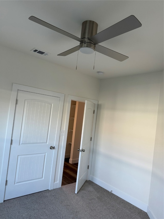 unfurnished bedroom with carpet floors, a closet, and ceiling fan