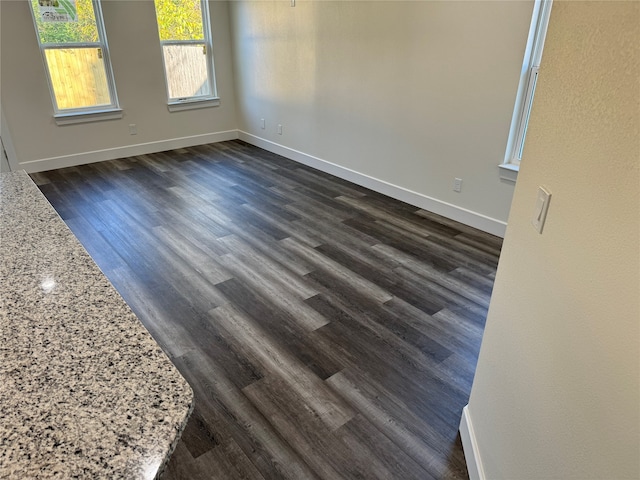 unfurnished room featuring dark hardwood / wood-style flooring