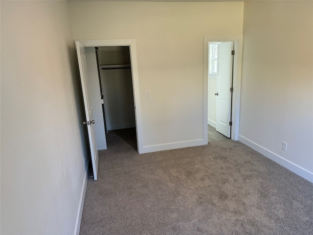 unfurnished bedroom with carpet and a closet