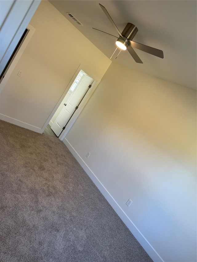 bonus room with ceiling fan and carpet