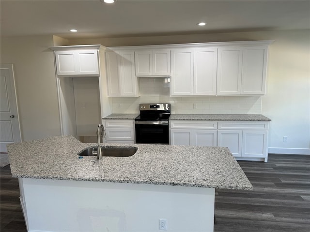 kitchen featuring a center island with sink, sink, electric range, white cabinetry, and tasteful backsplash