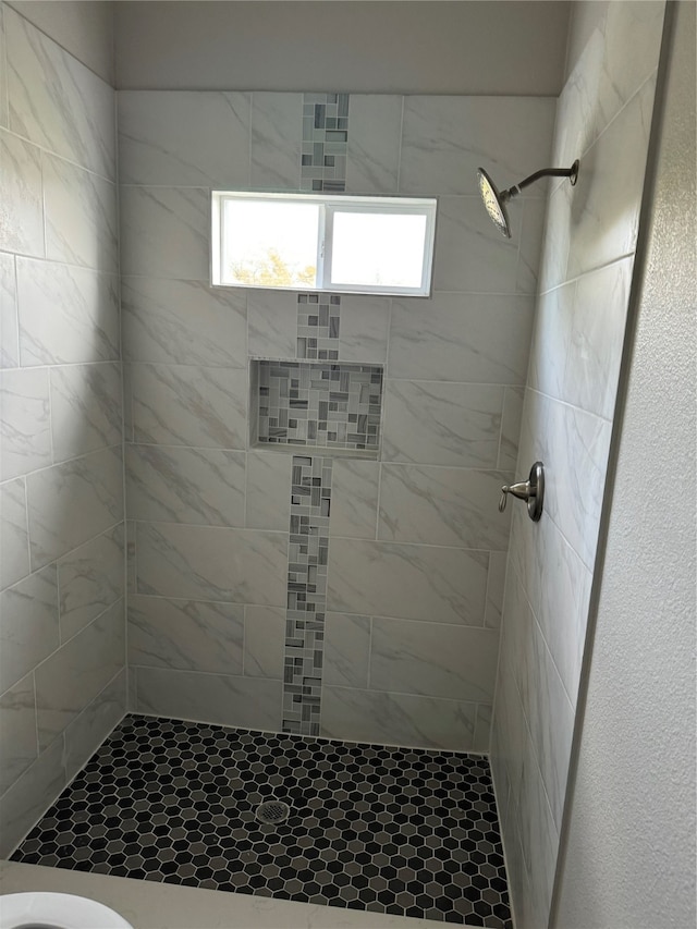 bathroom with a tile shower