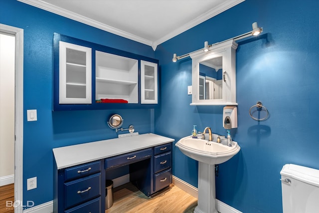 bathroom featuring toilet, ornamental molding, and wood-type flooring