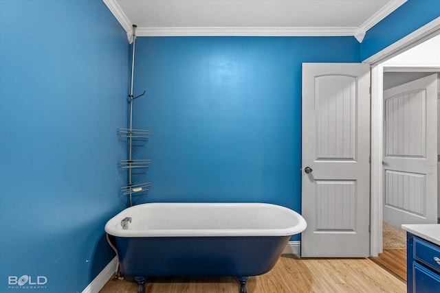 bathroom featuring vanity, a bathtub, ornamental molding, and hardwood / wood-style floors