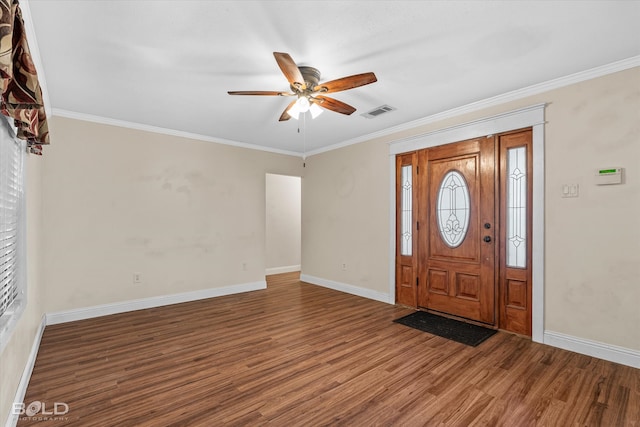 foyer with dark wood-type flooring, ceiling fan, and ornamental molding