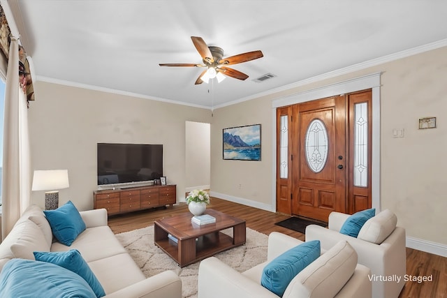 living room with ornamental molding, light wood-type flooring, and ceiling fan