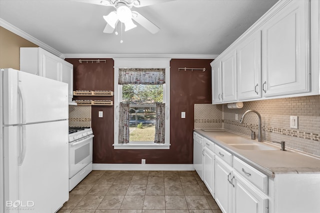 kitchen with white appliances, backsplash, white cabinetry, and sink