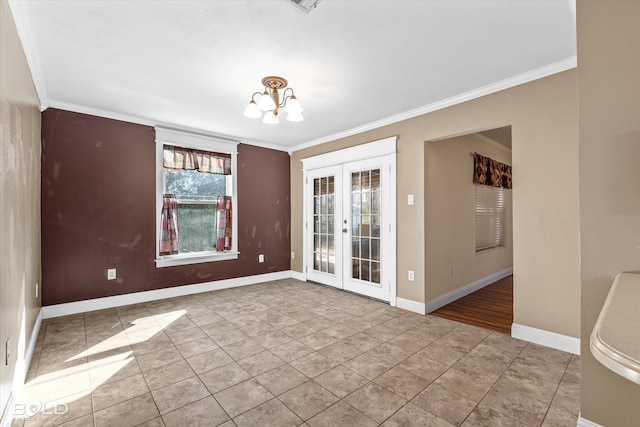 empty room featuring french doors, a notable chandelier, and ornamental molding