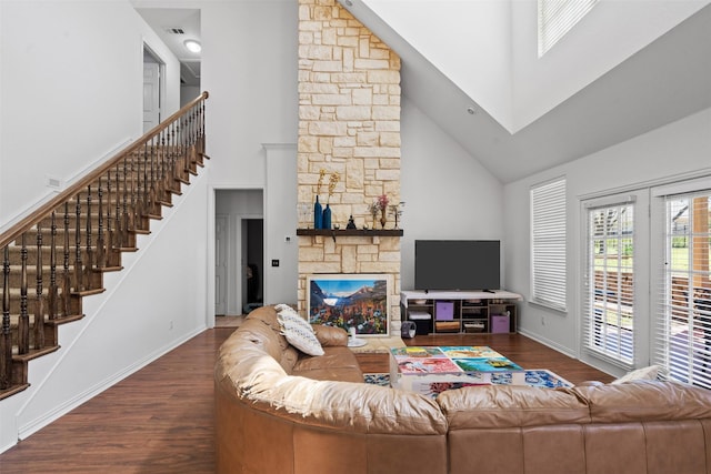 living room featuring a fireplace, dark hardwood / wood-style floors, and high vaulted ceiling