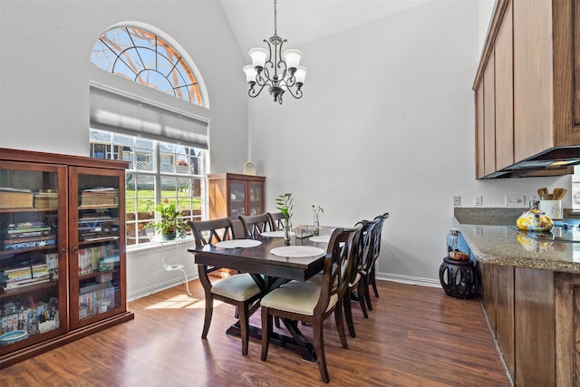 dining room featuring high vaulted ceiling, a chandelier, and dark hardwood / wood-style floors