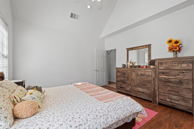 bedroom featuring ceiling fan, high vaulted ceiling, and dark hardwood / wood-style floors