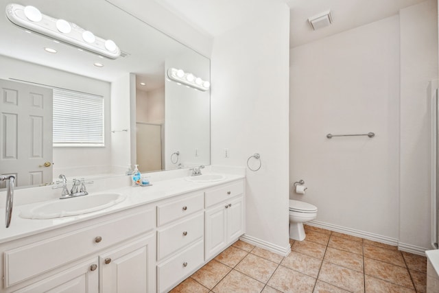 bathroom with toilet, vanity, tile patterned floors, and an enclosed shower