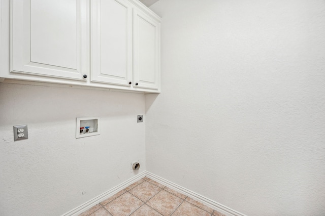 laundry area featuring hookup for an electric dryer, cabinets, light tile patterned floors, and washer hookup