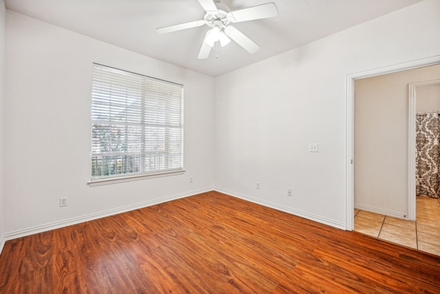 empty room featuring ceiling fan and hardwood / wood-style flooring