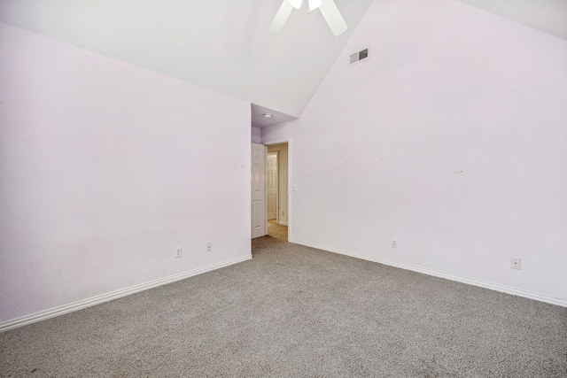 carpeted spare room with ceiling fan and high vaulted ceiling