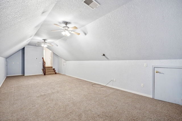 bonus room with carpet flooring, ceiling fan, a textured ceiling, and vaulted ceiling