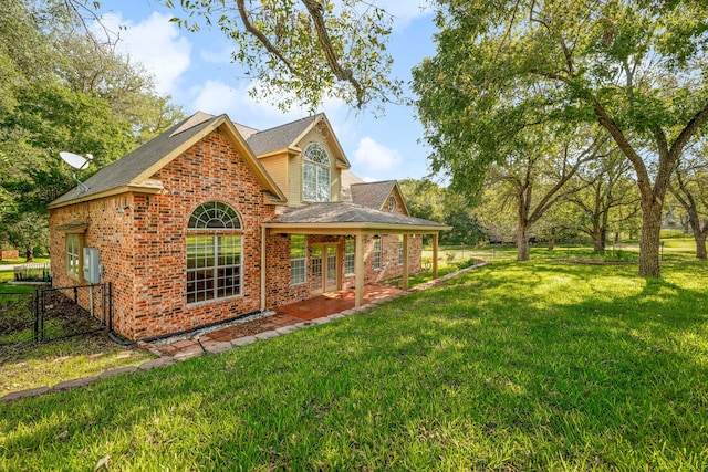 back of house featuring a yard