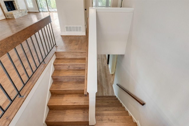 staircase featuring wood-type flooring and plenty of natural light