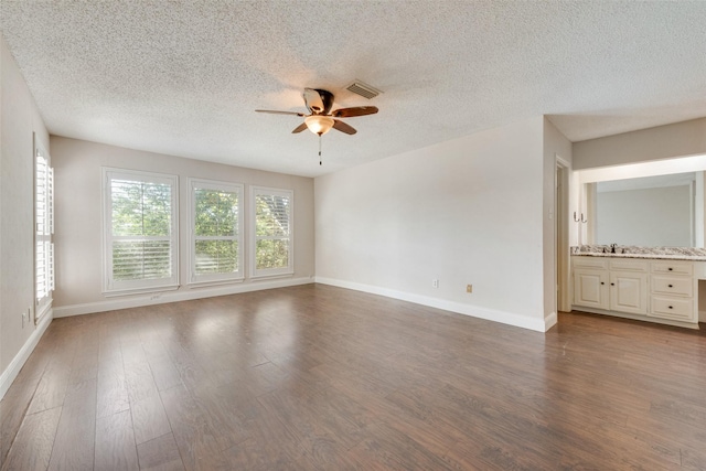 spare room featuring ceiling fan, a textured ceiling, and hardwood / wood-style floors