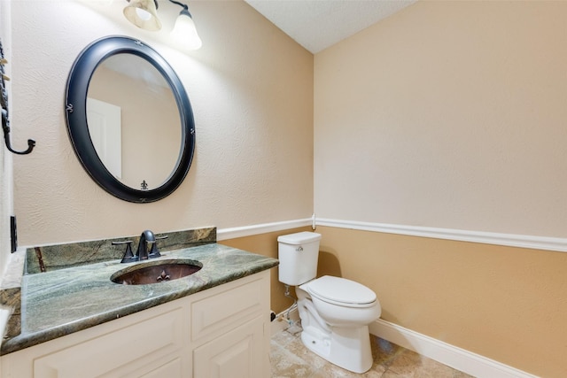 bathroom with toilet and vanity