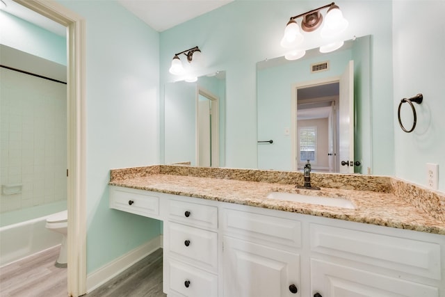 full bathroom featuring toilet, vanity, shower / washtub combination, and hardwood / wood-style floors