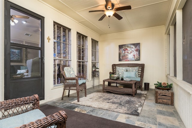 sunroom featuring ceiling fan