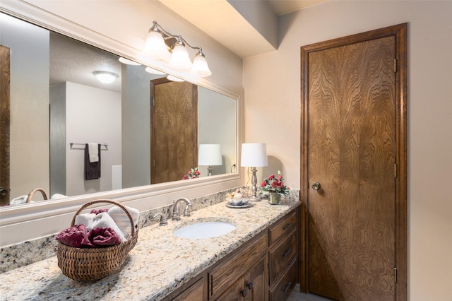 bathroom with vanity and a textured ceiling