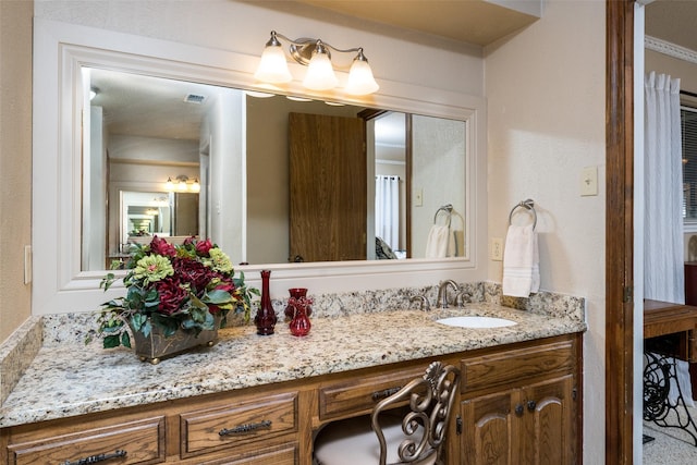 bathroom featuring vanity and crown molding