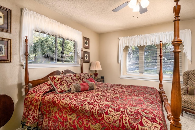 bedroom featuring ceiling fan and a textured ceiling