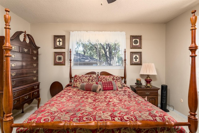 bedroom with light carpet and a textured ceiling