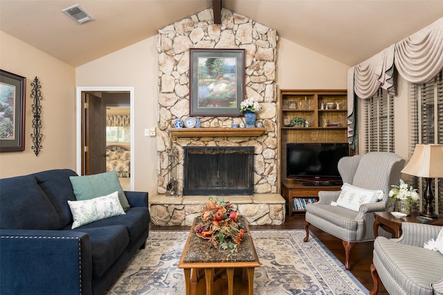 living room with lofted ceiling with beams, wood-type flooring, and a fireplace