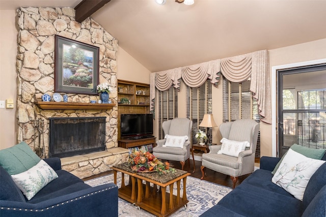 living room featuring hardwood / wood-style floors, vaulted ceiling with beams, and a fireplace