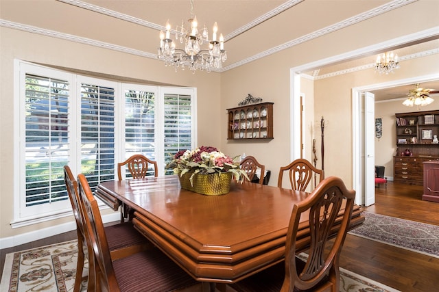 dining space with dark hardwood / wood-style floors, crown molding, and ceiling fan with notable chandelier