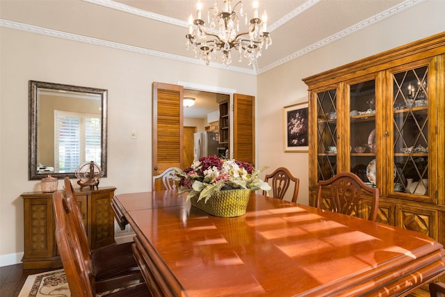 dining space featuring crown molding, dark wood-type flooring, and an inviting chandelier