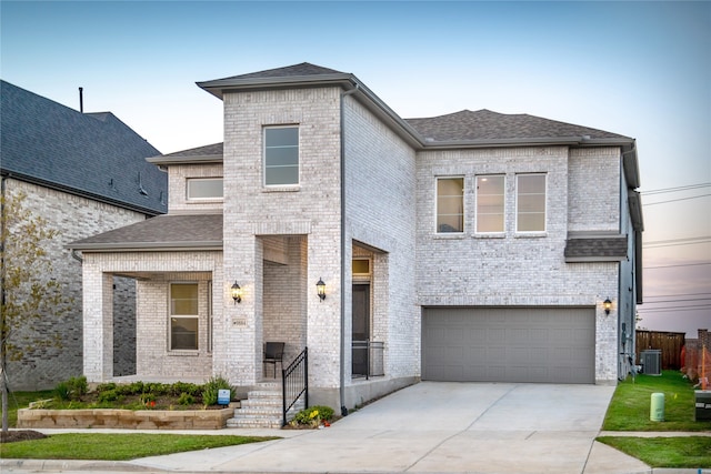 view of front of property with a garage and central air condition unit