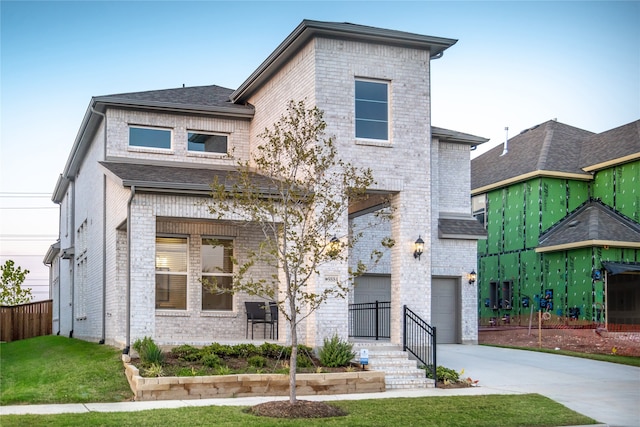 view of front of house featuring a front yard and a garage