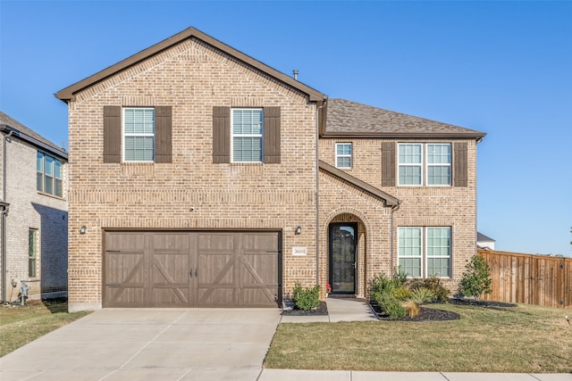 view of front of property with a front yard and a garage