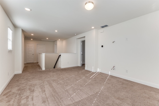 unfurnished room with light colored carpet