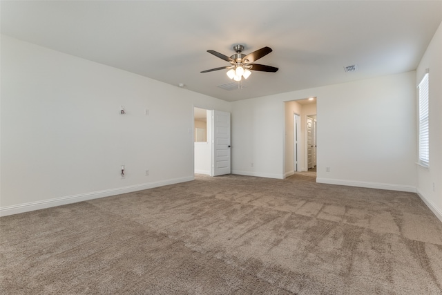 unfurnished room featuring light colored carpet and ceiling fan