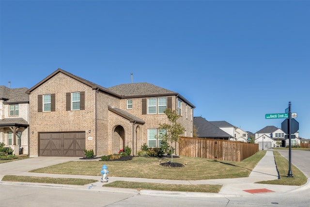 view of front facade with a front yard and a garage