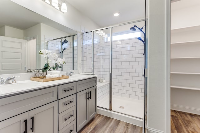 bathroom featuring vanity, hardwood / wood-style floors, and walk in shower