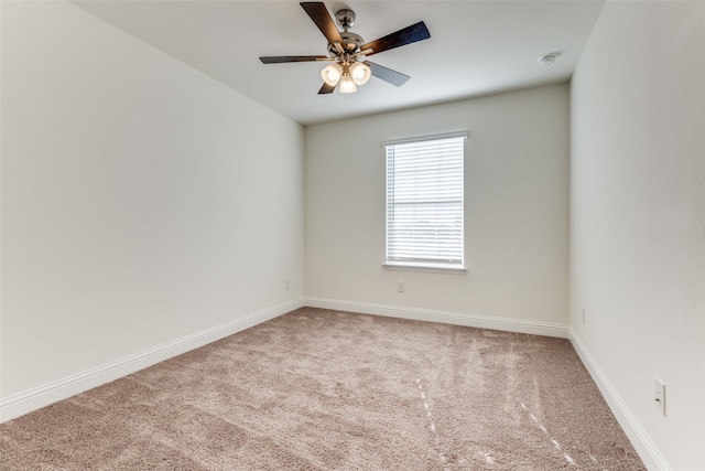 unfurnished room with light colored carpet and ceiling fan