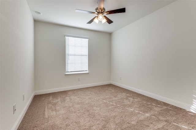 carpeted spare room with ceiling fan