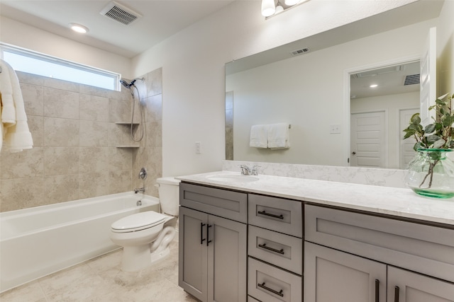 full bathroom with vanity, tiled shower / bath combo, toilet, and tile patterned flooring