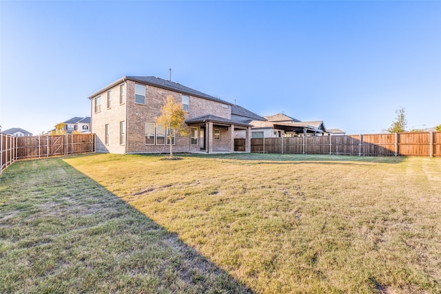 back of house with a lawn