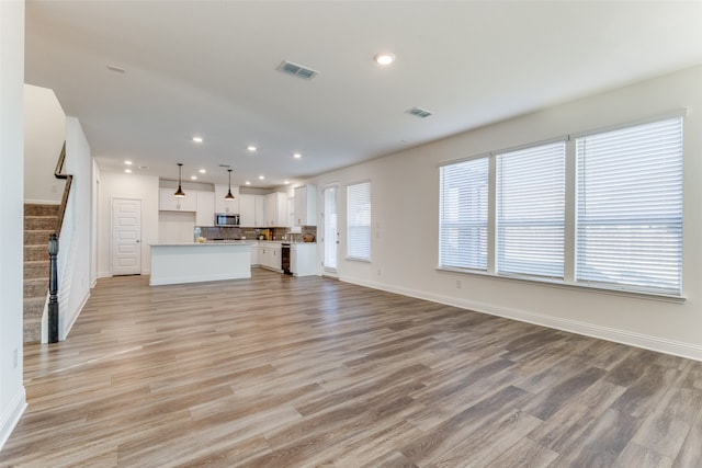 unfurnished living room with light wood-type flooring