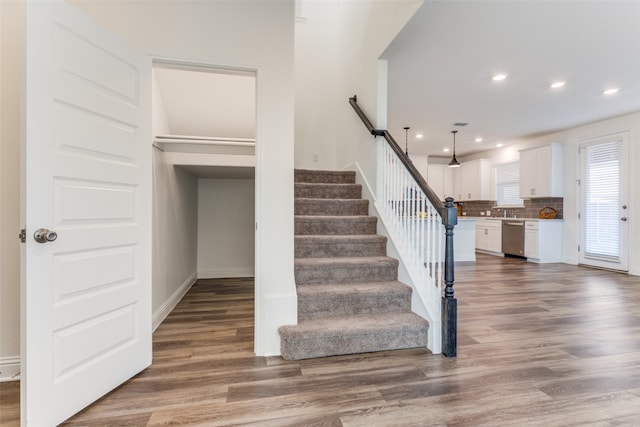 stairway featuring hardwood / wood-style flooring