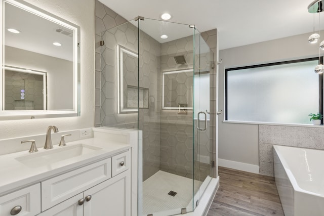 bathroom featuring separate shower and tub, wood-type flooring, and vanity