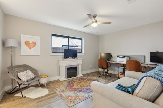 living room with light wood-type flooring and ceiling fan